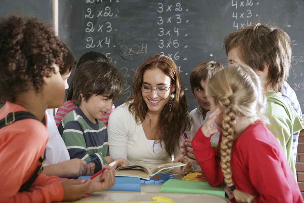 Group of kids around teacher