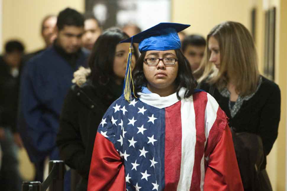 DREAMER student in American flag cap and gown