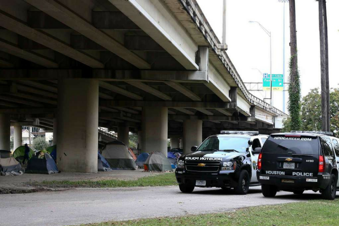 Houston police outside of homeless encampment.