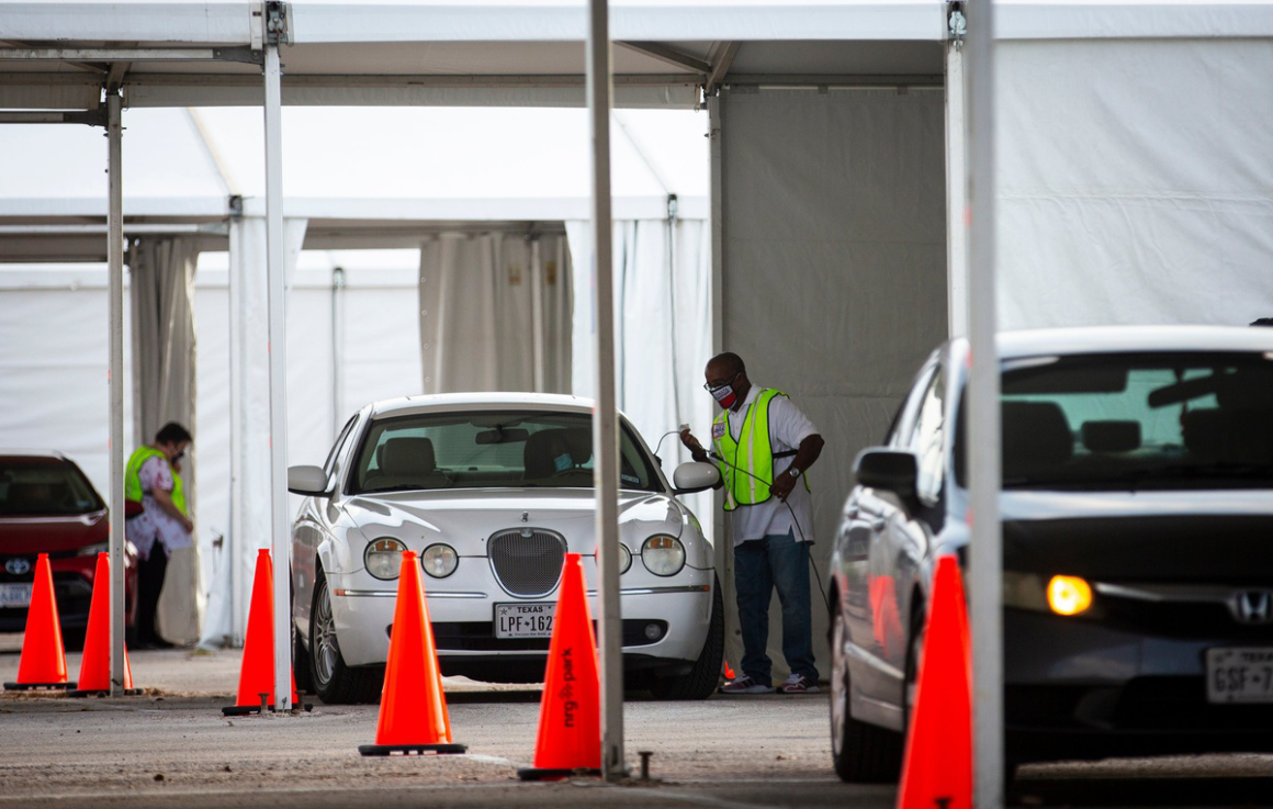 Cars line up during the pandemic to vote by drive-thru