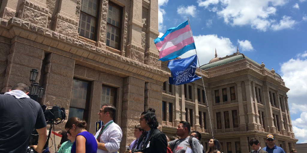 trans flag flying outside of the Texas Capitol
