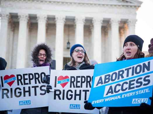 People holding pro-abortion signs in front of the Supreme Court