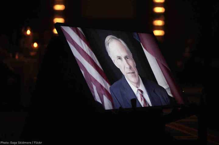 Greg Abbott on TV monitor screen