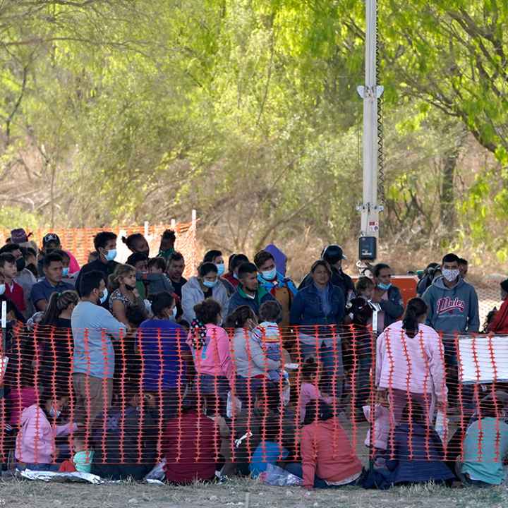 Migrants in custody at U.S. Customs and Border Protection processing area under the Anzalduas International Bridge, Friday, March 19, 2021, in Mission, Texas.