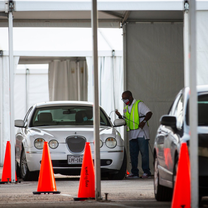Cars line up during the pandemic to vote by drive-thru