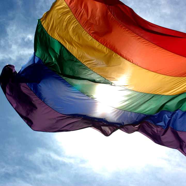 rainbow flag in blue skies