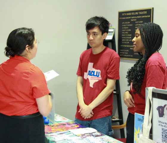 image of two people tabling and wear an aclu of tx t shirt