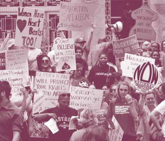 Crowd of people holding pro-abortion signs